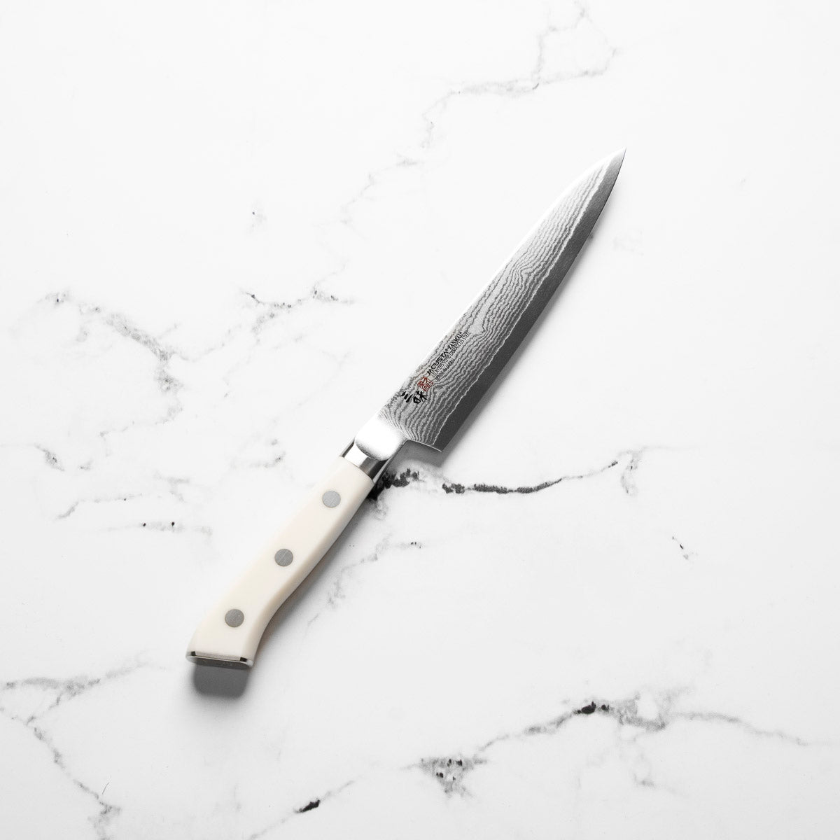 Mcusta Zanmai Corian Classic VG10 Damascus Petty 150mm - angled view